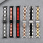 Mixed-color three-strand metal watch bands laid out, including silver, red, and black