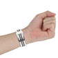 Two-color silicone watch band close-up, white perforated strap with dark underside buckle