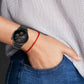 Black silicone watch band on wrist with round smartwatch face