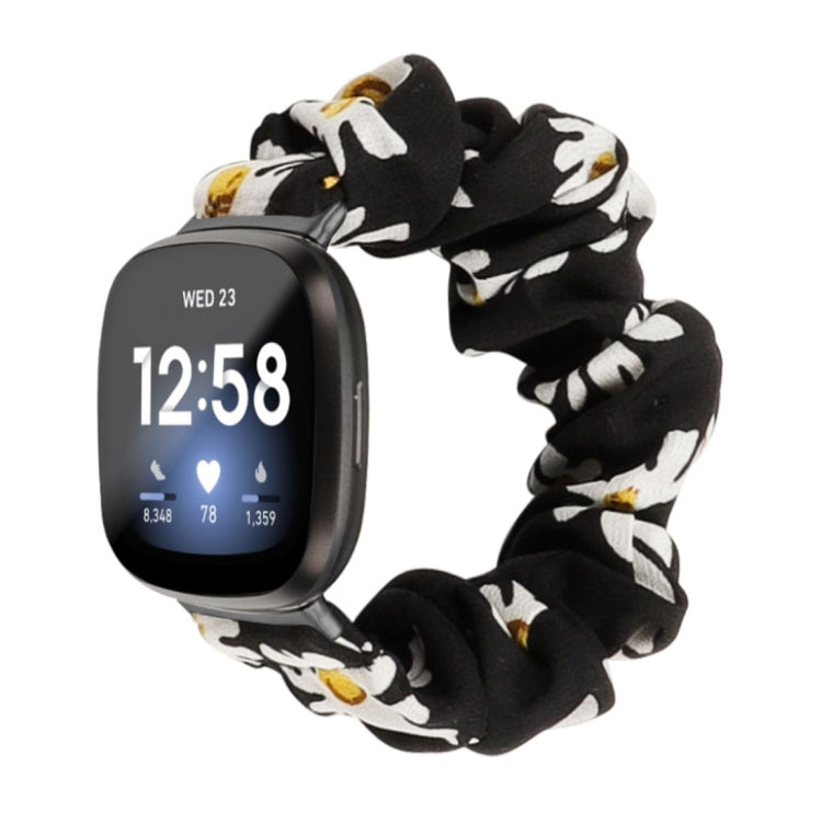 Black cloth watch band with white floral print; smartwatch shown.