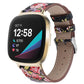 Black leather watch band with colorful floral print, stitched holes, and silver buckle.