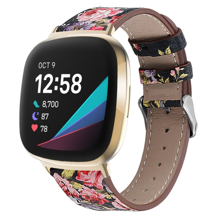 Black leather watch band with colorful floral print, stitched holes, and silver buckle.