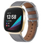 Gray leather watch band with stitched holes and silver buckle for smartwatch.