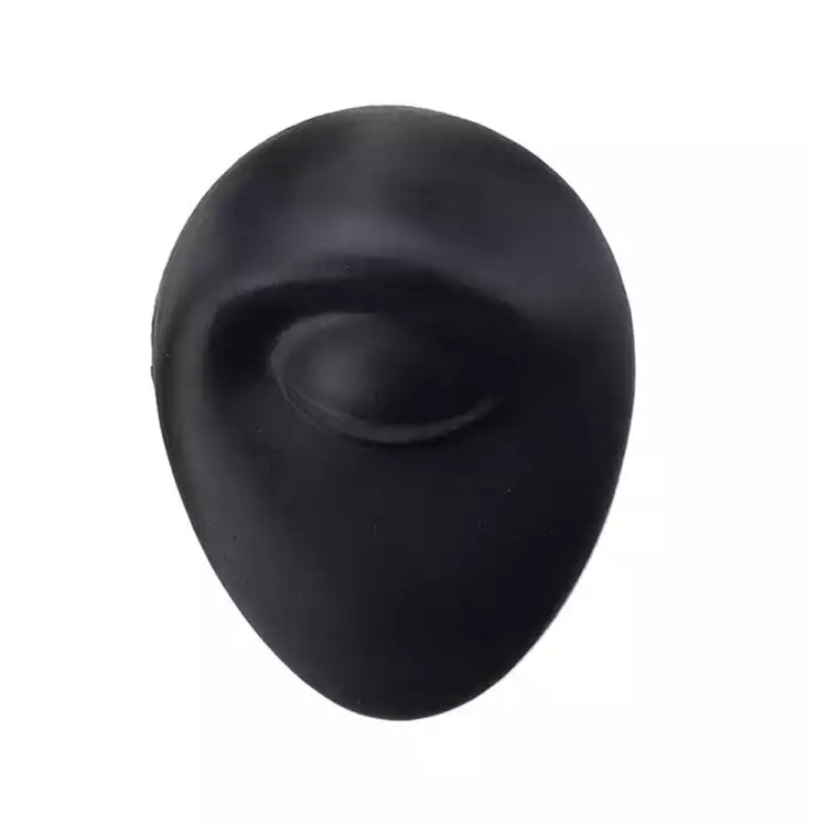 Black silicone facial feature insert with curved mouth-like indentation
