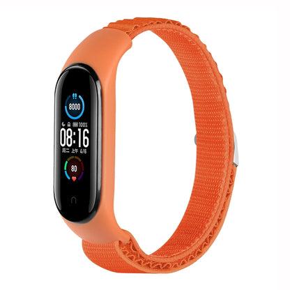 Orange nylon loop watch band with fitness tracker attached, adjustable strap.