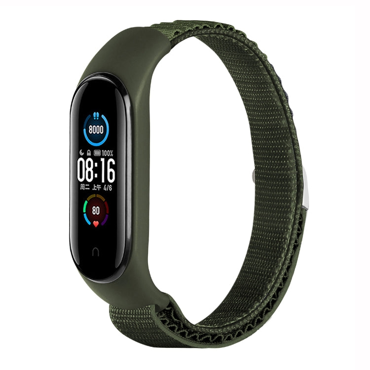 Olive green nylon loop watch band with fitness tracker attached, adjustable strap.