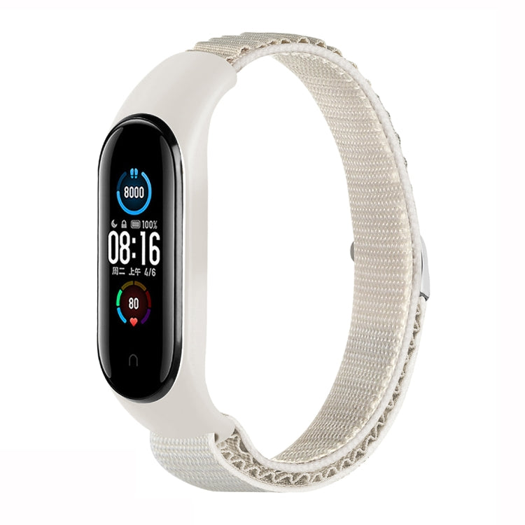 Starlight white nylon loop watch band with fitness tracker attached, adjustable strap.