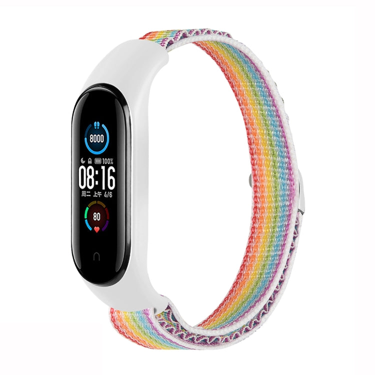 Rainbow nylon loop watch band with fitness tracker attached, adjustable strap.