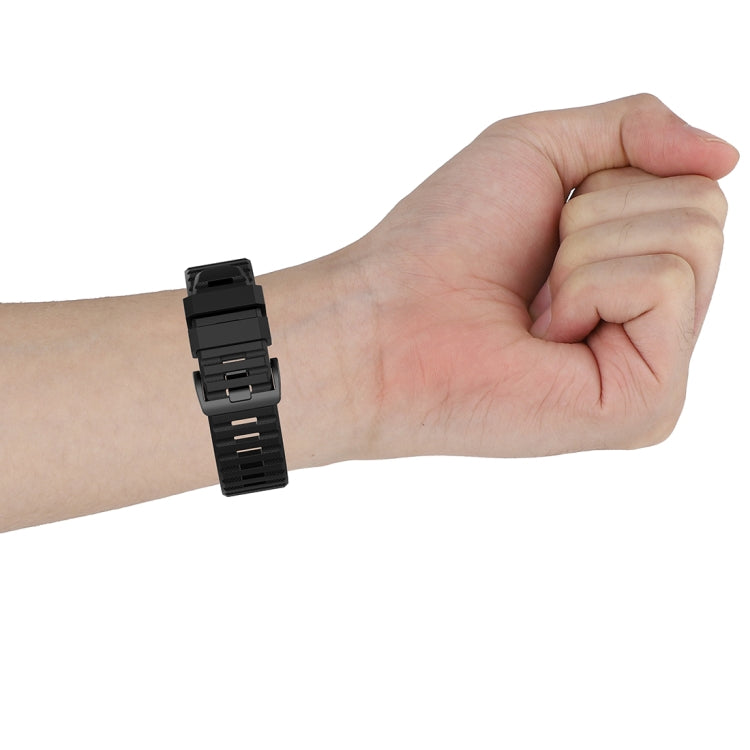 Black 22mm textured watch strap with plastic quick-release buckle, wrist side view