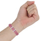Pink leather watch strap on hand with silver buckle and punched holes