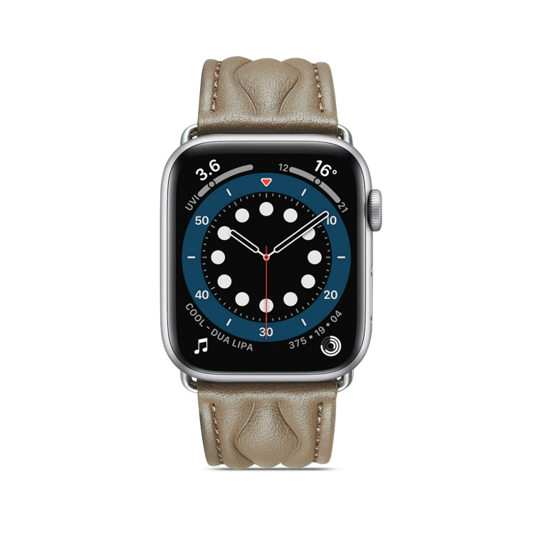 Light beige leather Apple Watch strap with stitched texture and metal buckle.
