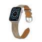 Taupe leather Apple Watch strap with brown underside and metal buckle hardware.
