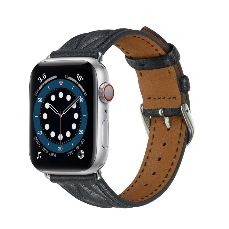 Dark leather Apple Watch strap with tan underside and metal buckle hardware.