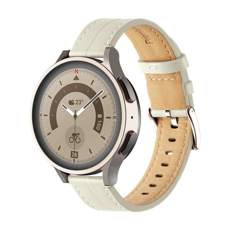 Off-white fluted leather watch band with stitched holes and metal buckle, tan underside.