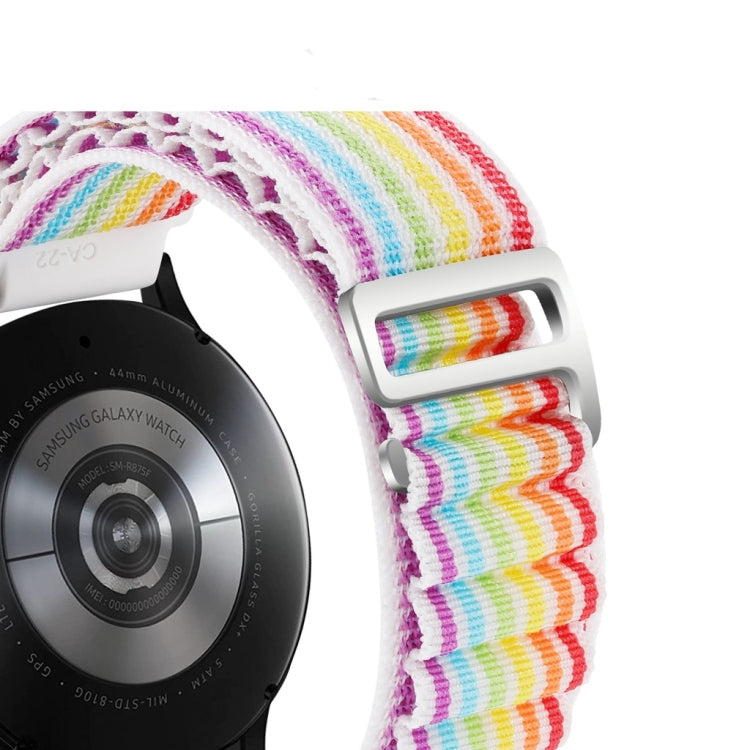 Close-up of rainbow nylon watch band with white buckle and metal loops.