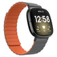 Orange silicone magnetic watch band with gray clasp, shown on a smartwatch with black screen
