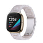 Transparent white resin link watch band with molded pattern, angled view on smartwatch