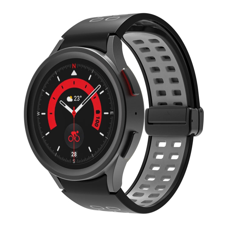 Black silicone watch band with double-row holes and fold-over buckle, light gray clasp.