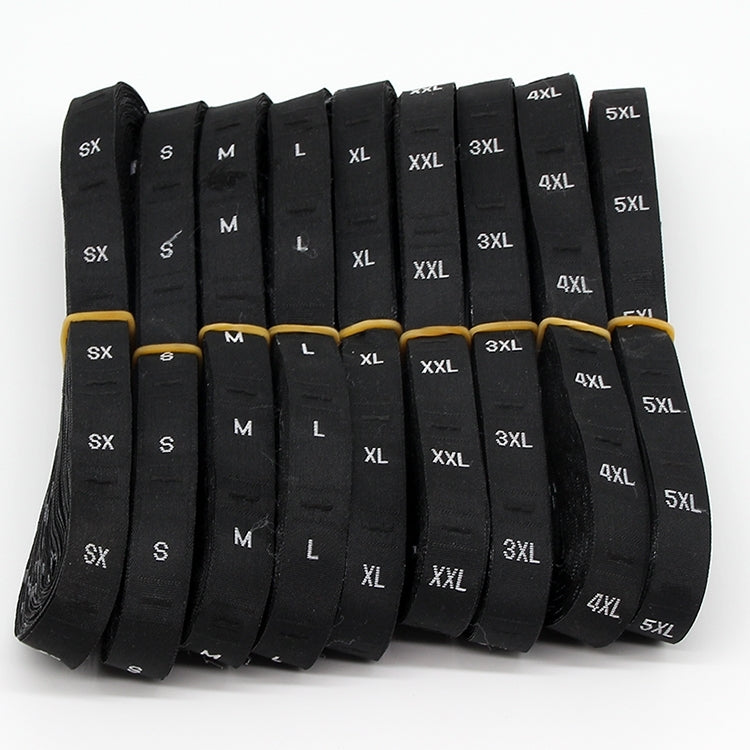 Roll of black polyester clothing size labels, printed XS to 5XL