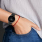 Genuine leather watch band in dark gray on wrist with metal buckle and strap holes