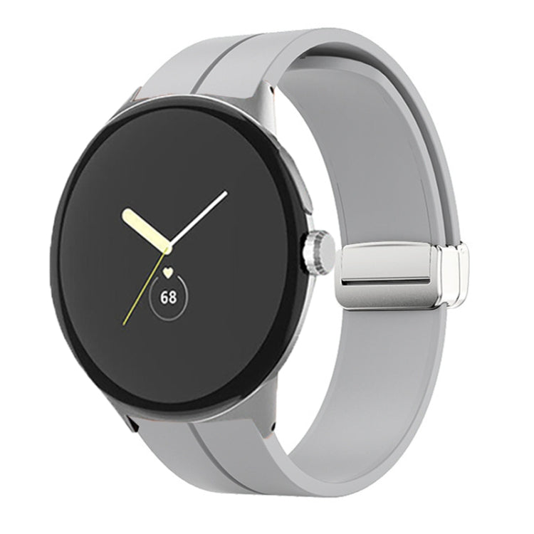 Black silicone watch band with folding buckle and silver clasp, shown on watch.