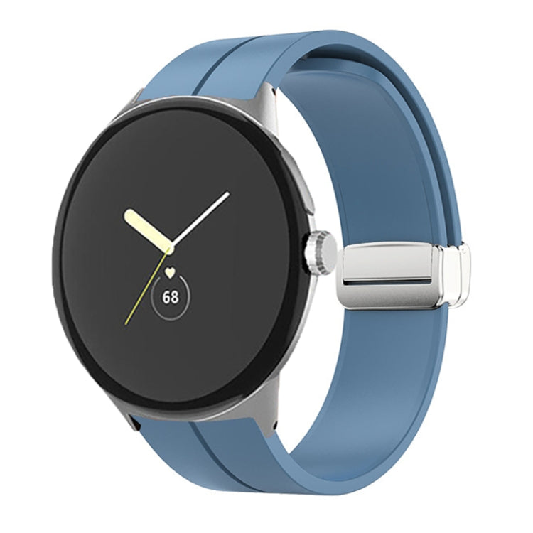 Blue silicone watch band with folding buckle and silver clasp, shown on watch.