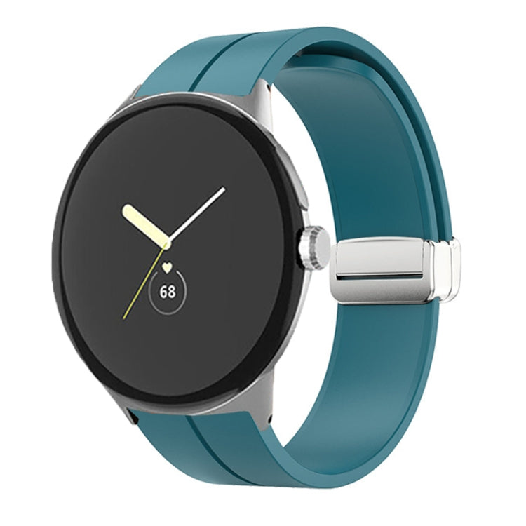 Teal silicone watch band with folding buckle and silver clasp, shown on watch.