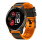 Two-tone silicone watch band in orange with dark gray buckle and vented links.