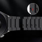 Quick-release pin detail on dark metal watch band with linked segments