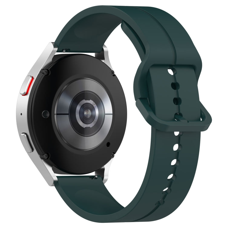 Dark green silicone watch band, clasp side view with perforation holes and strap curvature.