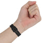 Silicone watch band on wrist with prong buckle and adjustment holes, black