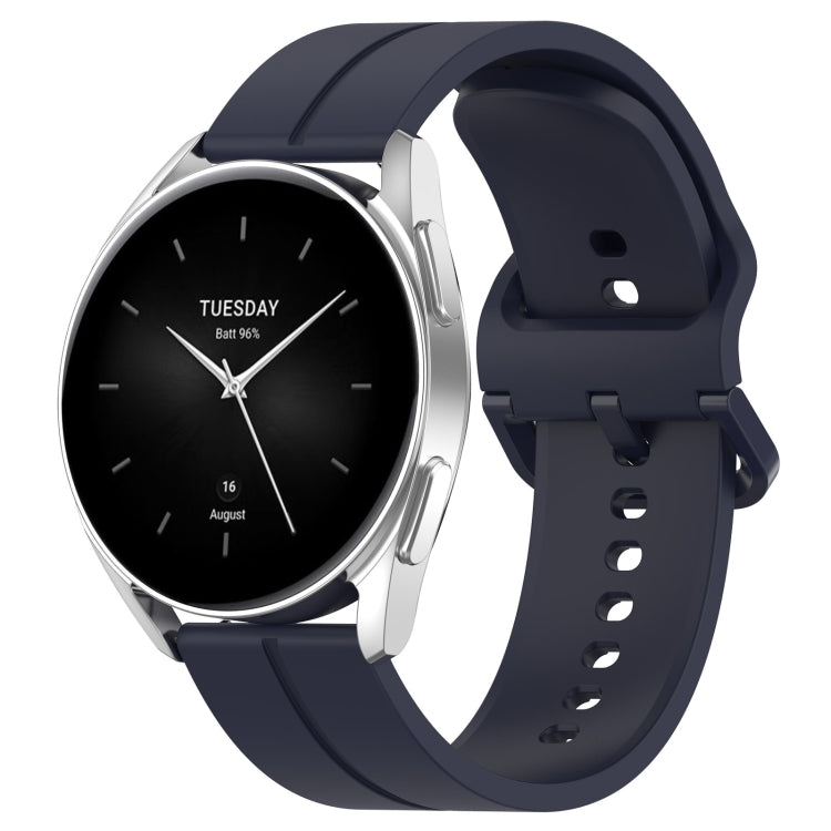 Navy silicone watch band with clasp, rear holes visible along the strap.