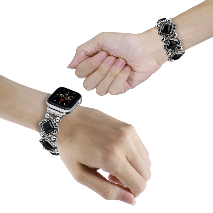 Retro pine stone metal watch band on wrist with black square cabochon links