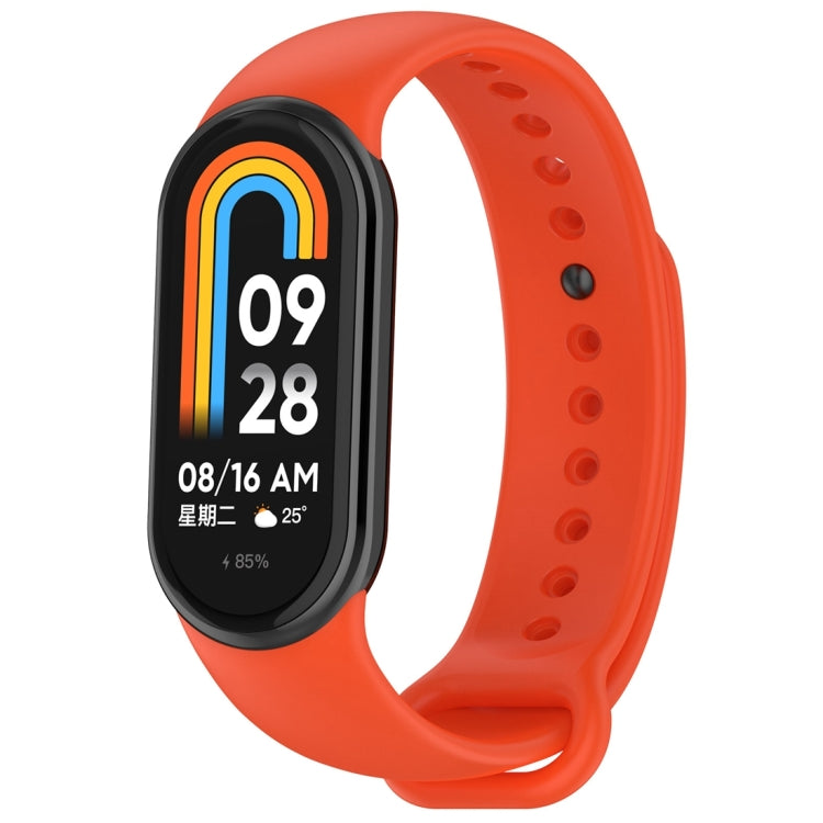 Orange silicone smartwatch band with oval tracker body, perforated holes