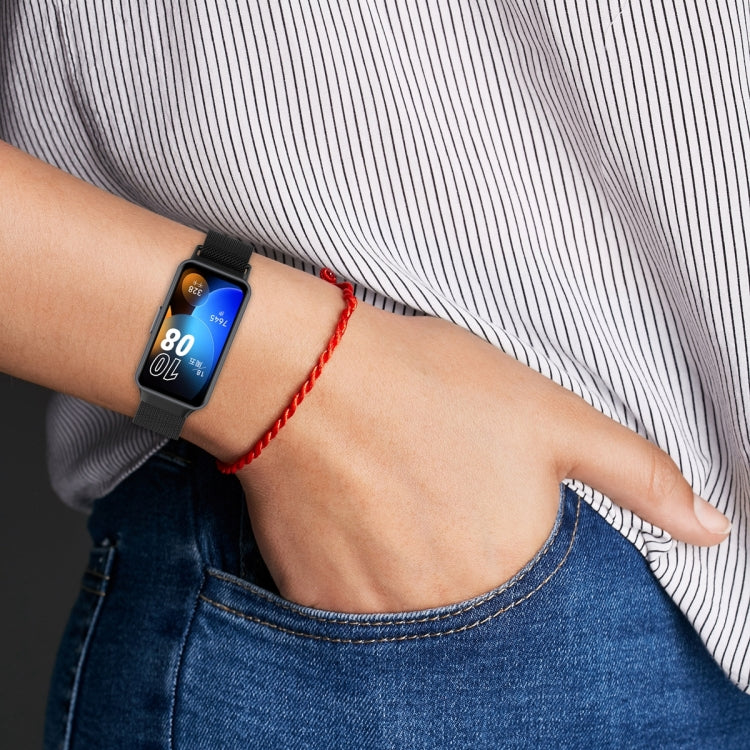 Black Milanese metal watch band on wrist with mesh strap and clasp