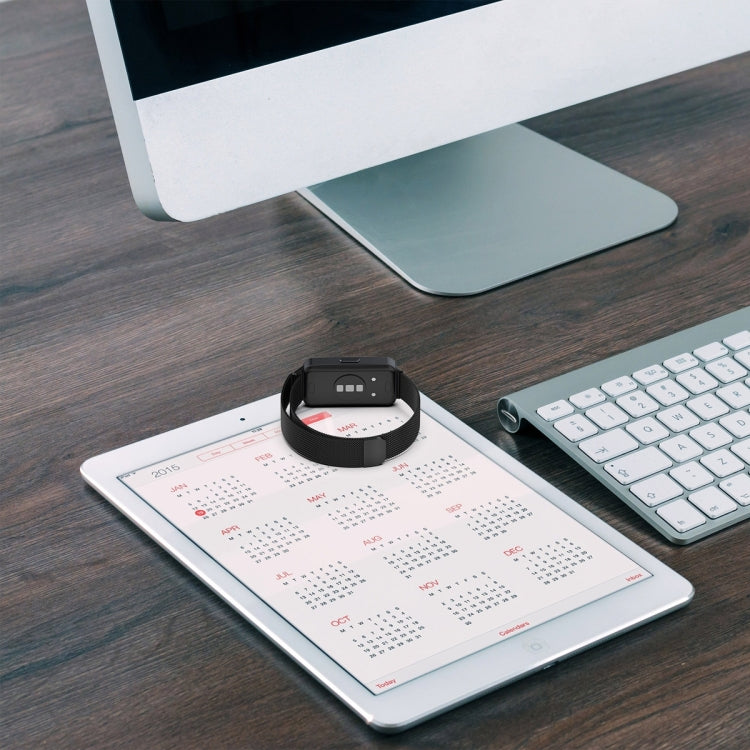 Milanese metal watch band with black clasp, flat on a surface for a smartwatch