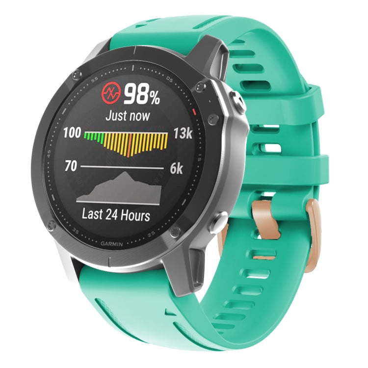 Light teal silicone watch band with rose-gold buckle and adjustable holes