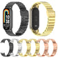 Assorted stainless steel watch bands in black, silver, gold, and rose gold.