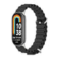 Black breathable silicone watch band with metal clasp and perforated links, watch display visible
