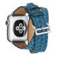 Angled close-up of blue embossed crown leather watch band with silver buckle