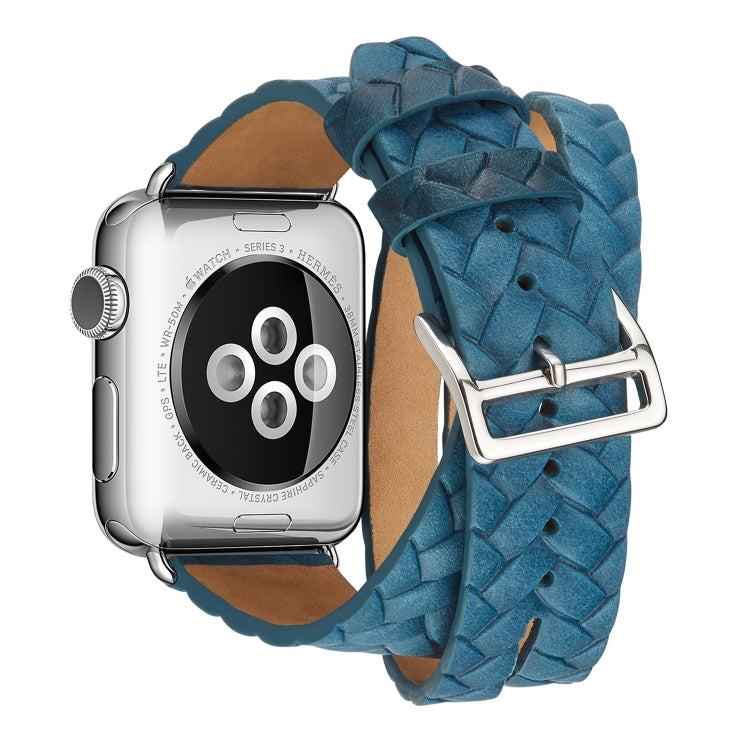 Angled close-up of blue embossed crown leather watch band with silver buckle