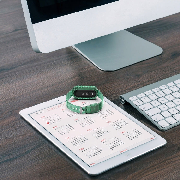 Green transparent silicone watch band with fitness tracker, lying on desk