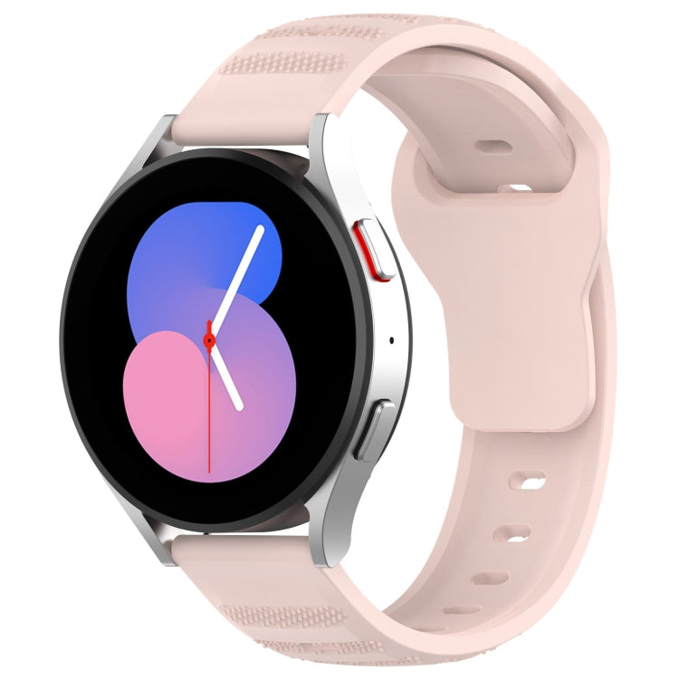 Light pink silicone watch band with textured dot pattern and multiple pin holes