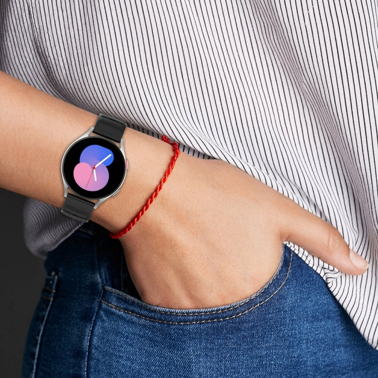 Black silicone watch band with dot-texture strap and multiple pin holes on wrist