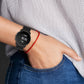 Black perforated silicone watch band worn on wrist