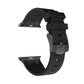 Black silicone Apple Watch band with textured clasp and vented link details