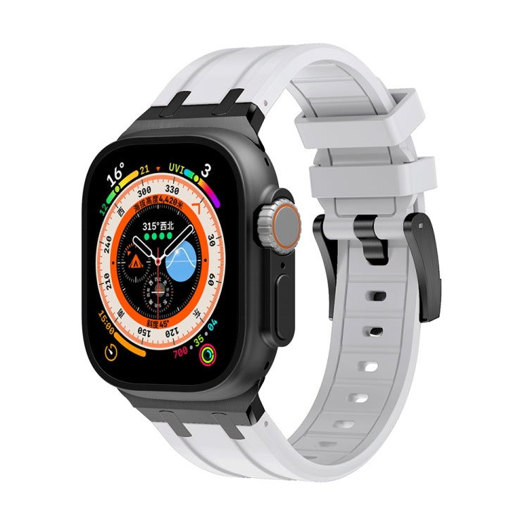 Black silicone watch band with metal buckle and strap holes for Apple Watch.