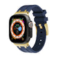 Blue silicone watch band with gold-tone buckle and strap holes for Apple Watch.