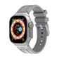 Light gray silicone Apple Watch band with orange buckle accent and ladder slots
