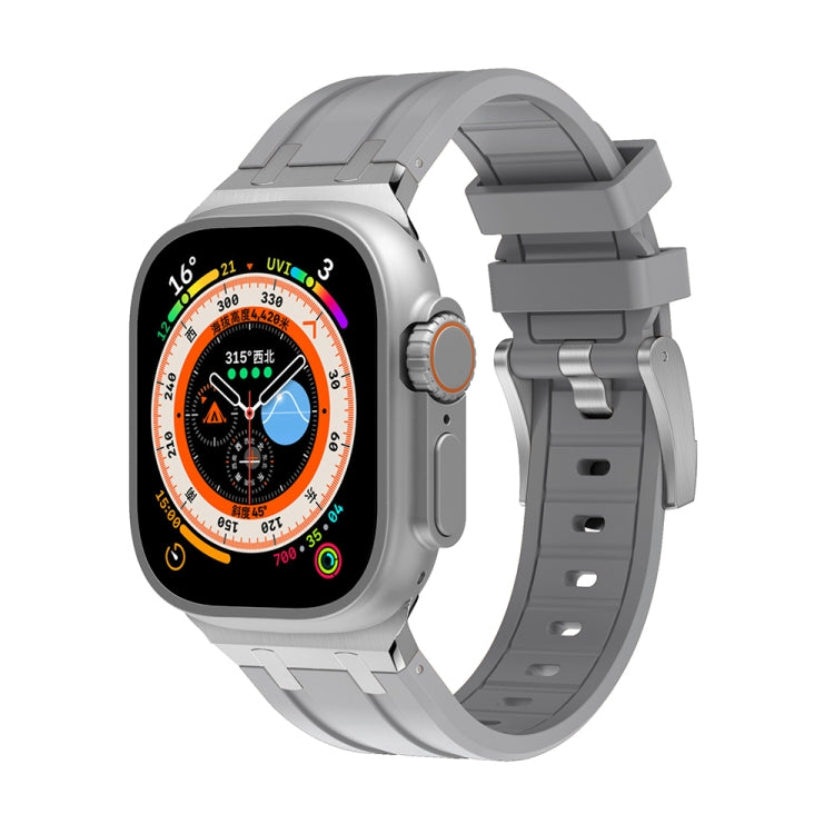 Light gray silicone Apple Watch band with orange buckle accent and ladder slots